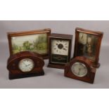 A collection of clocks, to include German alarm clock, French inlaid example, Smiths Cries of London