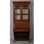 An oak lead glazed bureau bookcase. (190cm x 95cm)