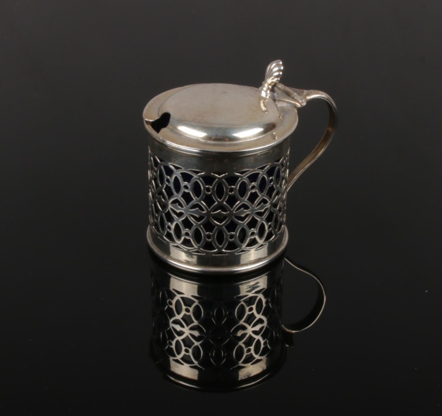 A Victorian pierced silver mustard pot with Bristol blue glass liner. Assayed London 1896. Silver 49