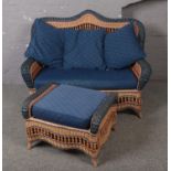 A rattan style conservatory suite consisting of sofa, two arm chairs, foot stool and table.