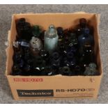 A collection of glass storage bottles, mainly coloured examples.