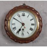 An oak cased Smith Astral wall clock with Roman numeral markers and rope twist effect border. (