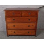 A mahogany two over three chest of drawers.