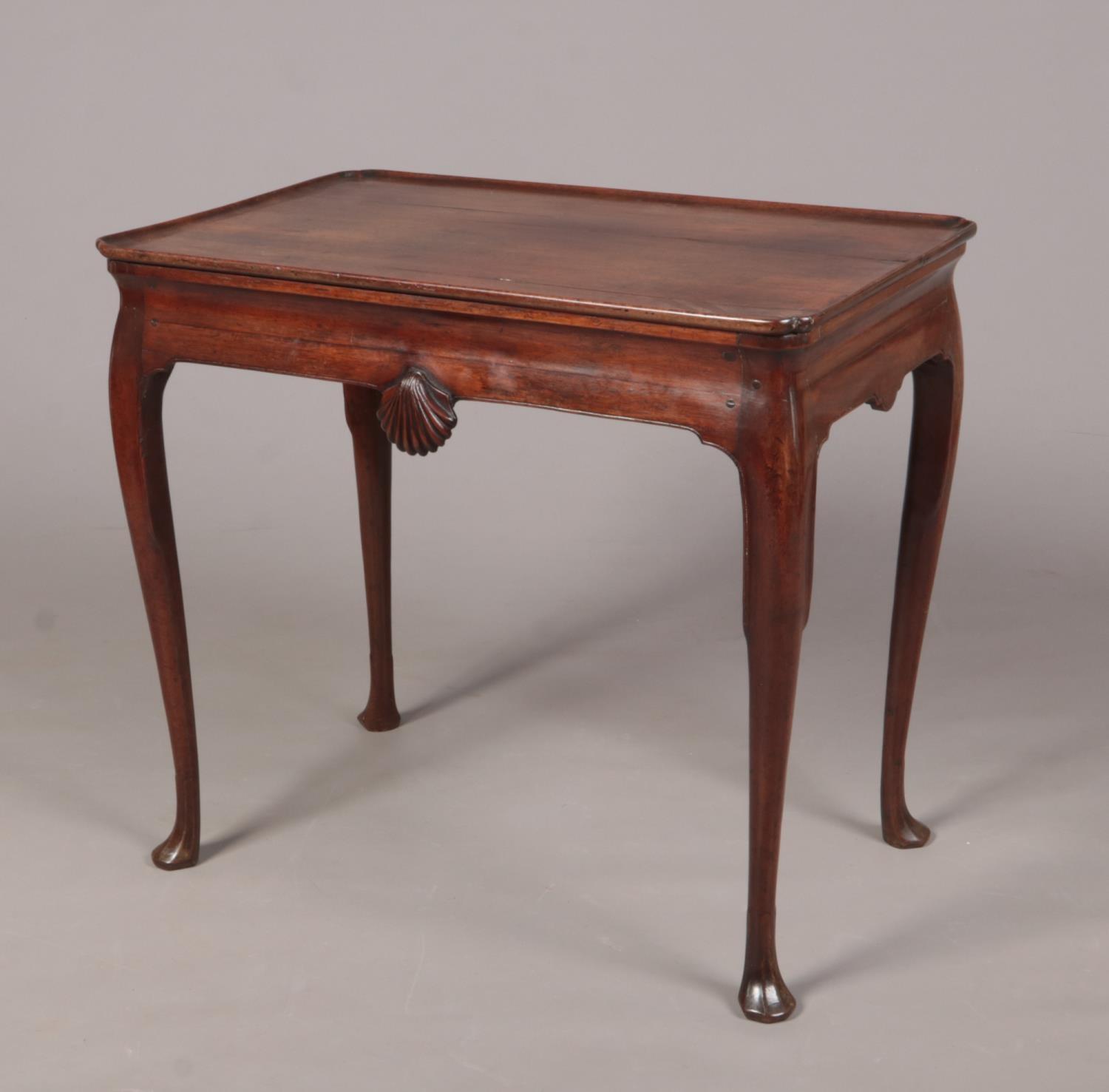A George II Irish mahogany silver table with notched rectangular dish top. With a pair of carved