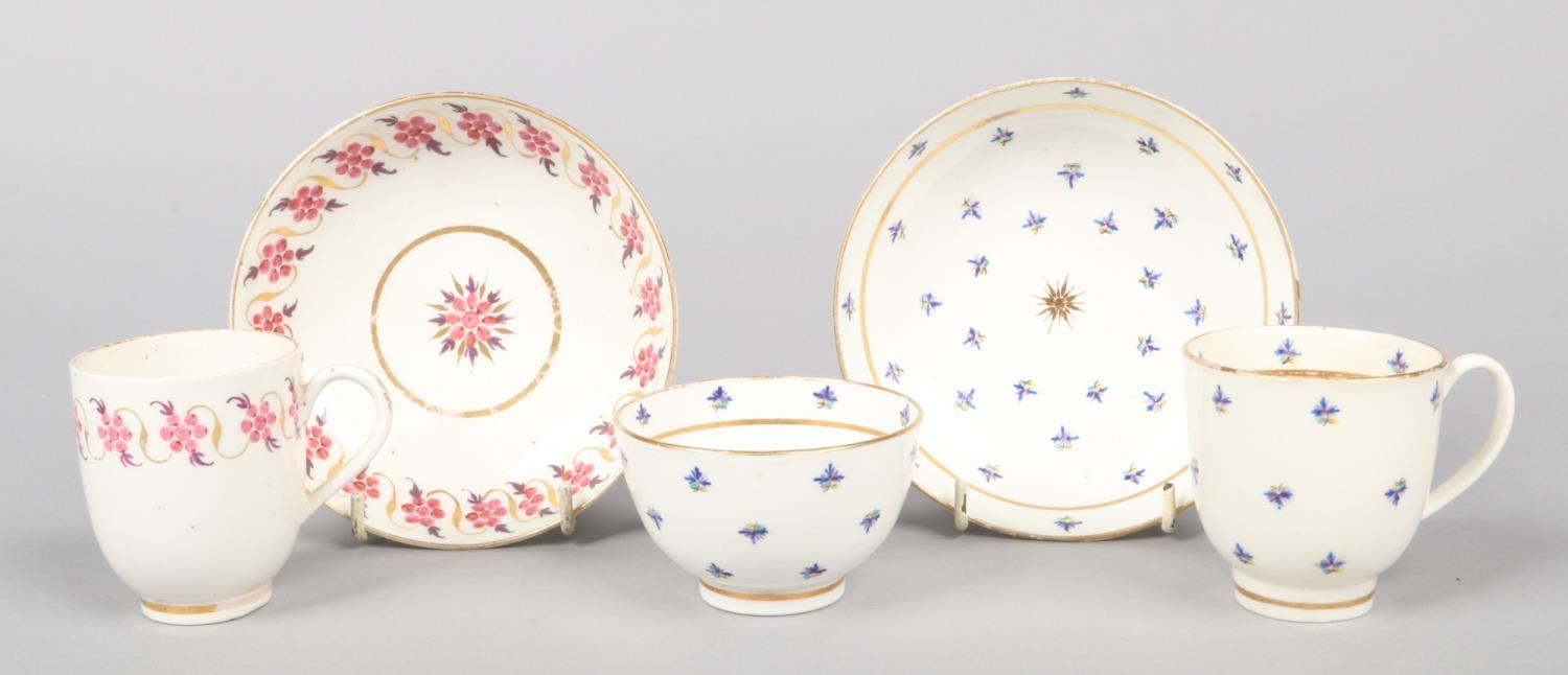 A Caughley trio comprising a teabowl and saucer and coffee cup painted in colours with cornflowers