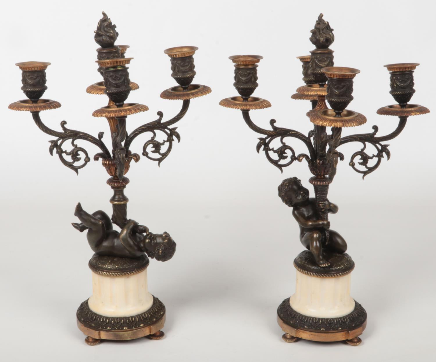 A pair of 19th century French parcel gilt bronze and marble five branch candelabra raised on flatted