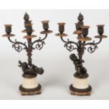 A pair of 19th century French parcel gilt bronze and marble five branch candelabra raised on flatted