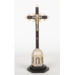 A 19th century Continental carved mother of pearl and ebonized Corpus Christi. Surmounted by a