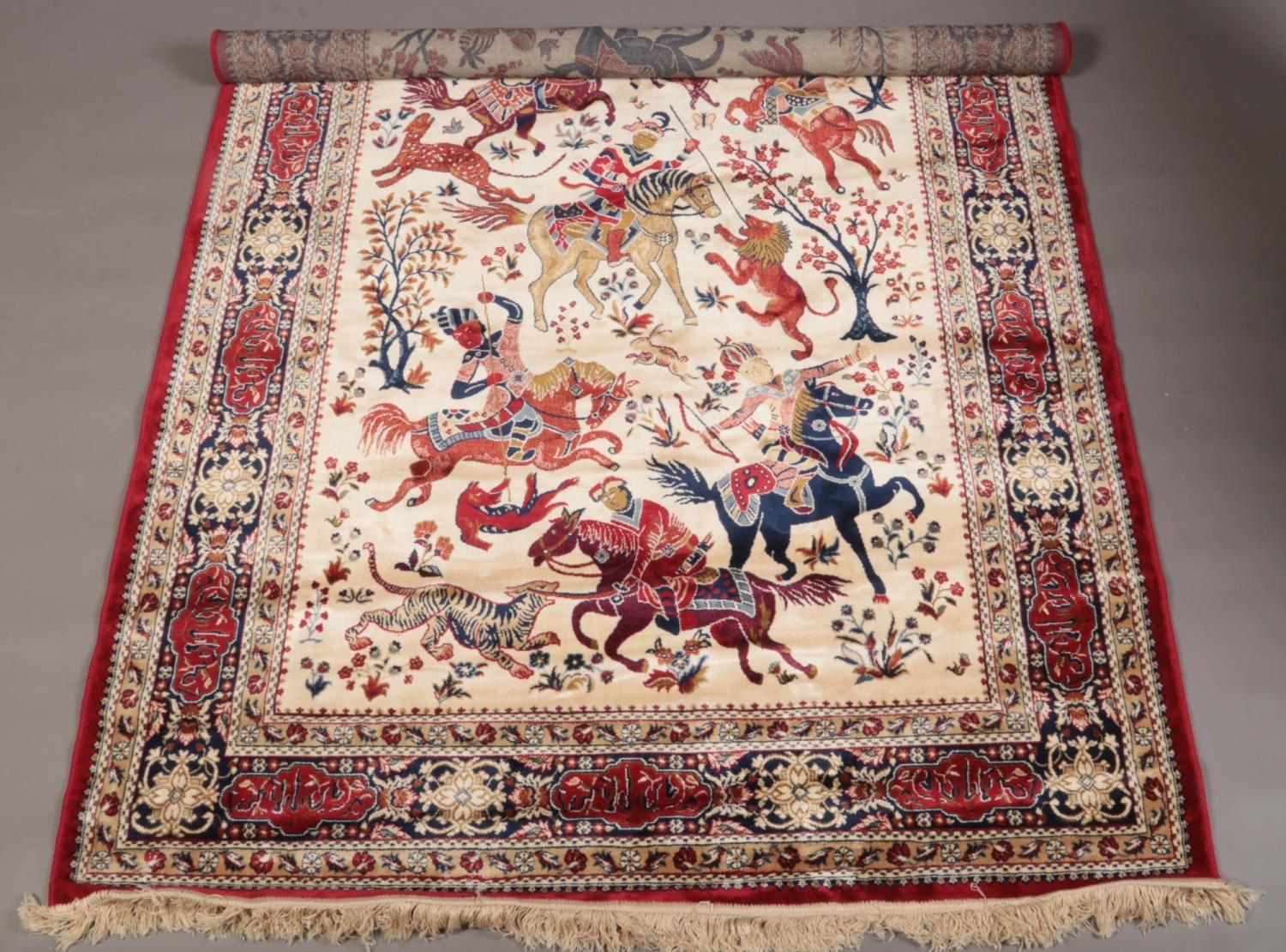 Red ground Kashmir rug with a traditional hunting scene, 240 x 160cm.