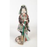 A Japanese Meiji period Kutani figure. Decorated in coloured glazes and formed as a maiden with a