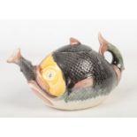A Victorian majolica novelty teapot and cover. Formed as a fish and decorated in coloured glazes,