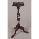 A Chippendale style mahogany wine table with hexagonal top having open fret gallery. Raised on an