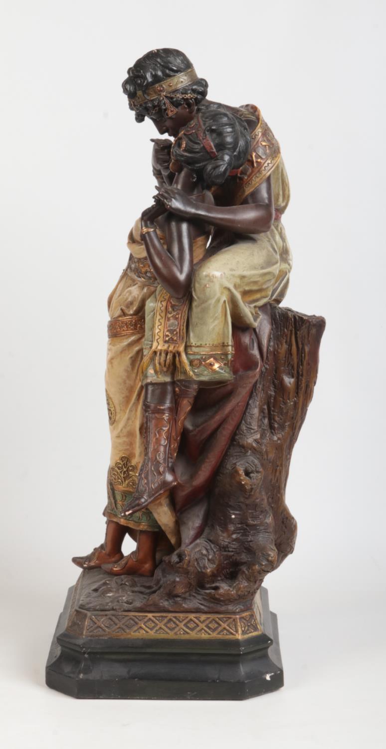 A large Art Nouveau painted terracotta figure group. Odalisque and companion. Raised on a canted - Image 2 of 4