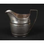 A George III silver cream jug with reeded strap handle. Assayed Sheffield 1803, 84 grams, 9.75cm.