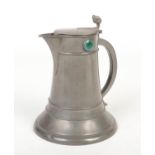 An Arts & Crafts pewter jug of spreading cylindrical form. With twin acorn thumbpiece and set with