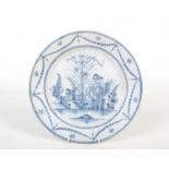 An 18th century English Delft blue and white charger. Painted with a typical Chinese landscape