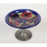 A Moorcroft pewter mounted tazza decorated on a blue ground with the pansies design. Impressed