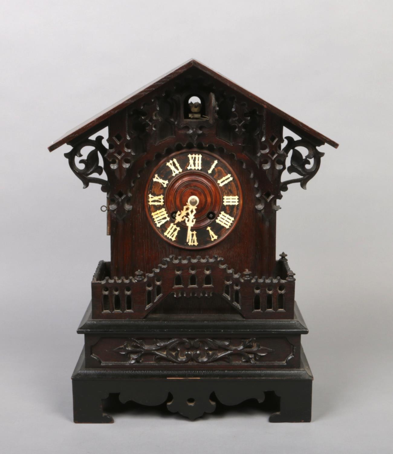 A 19th century Black Forest cuckoo mantel clock. With triangular pediment, acanthus scrolling