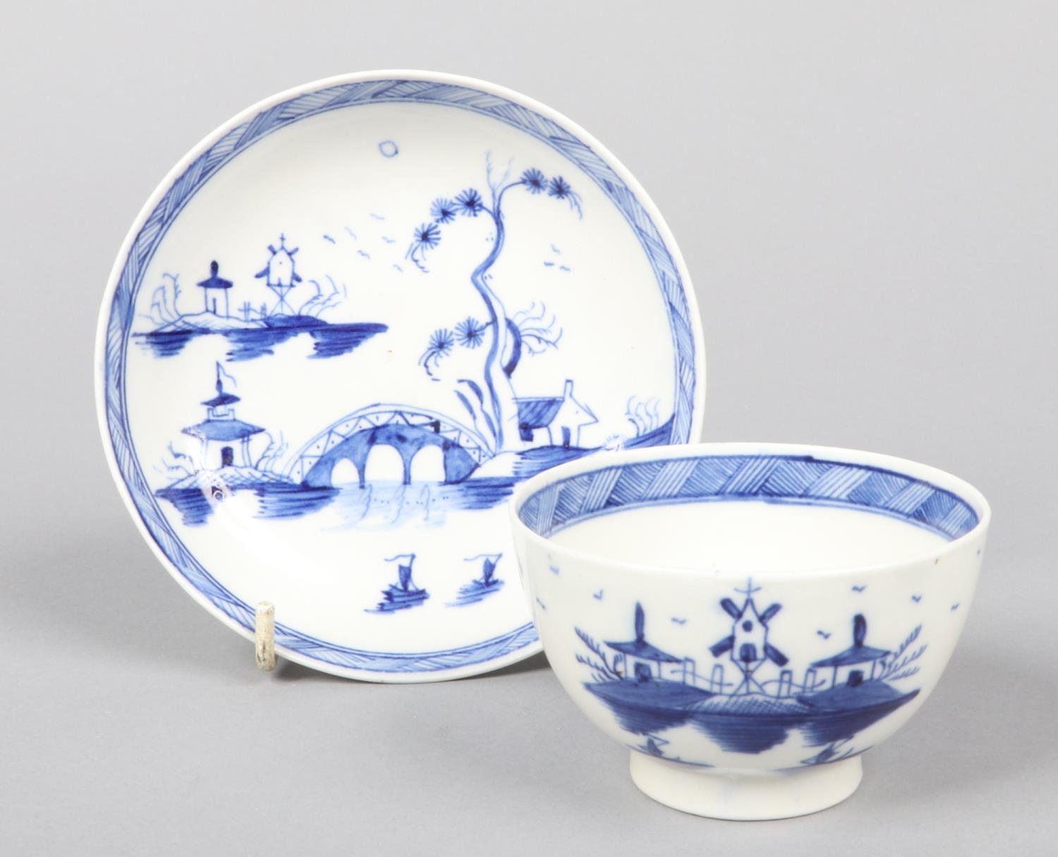 a Caughley teabowl and saucer. Painted in underglaze blue with the Bridge and Windmill pattern c.