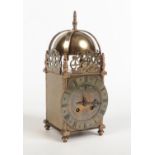 A 19th century brass cased lantern clock. Housing a French 8 day two train movement with platform