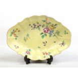 A Worcester scalloped lozenge shaped dish. Yellow ground, with gilt rim, enamelled with a bouquet