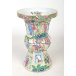 A large mid 19th century Cantonese gu shaped vase. Painted in coloured enamels with through