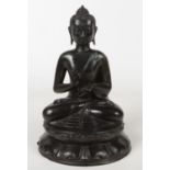 A 19th century Sino-Tibetan cast metal statue of a seated Buddha. Raised on a circular lotus plinth.