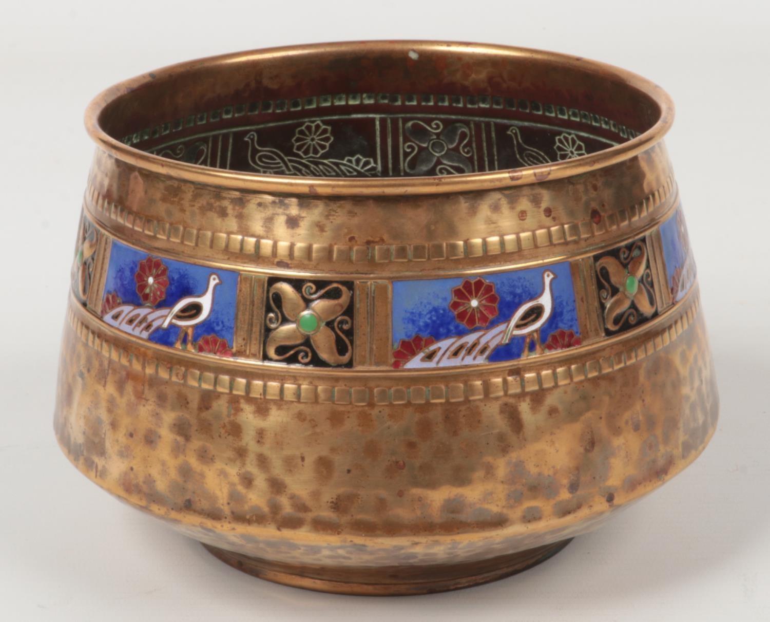 A WMF small planished brass planter. With an enamelled band depicting peacocks interspersed with