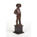 A bronze figure of a young boy raised on a square slate plinth. Modelled smoking a cigar, stood with