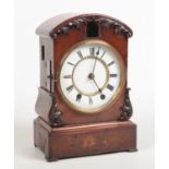 A 19th century German oak cased cuckoo clock. Dome topped, with applied carved scrollwork, white