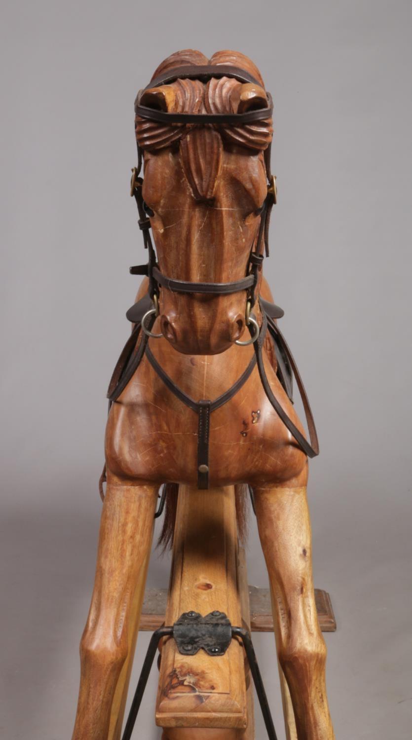 A large carved hardwood child's rocking horse with leather saddle and bridle, 105cm high. Stripped - Image 2 of 8