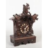 A 19th century Black Forest cuckoo clock striking on a gong. Carved with a squirrel and acanthus