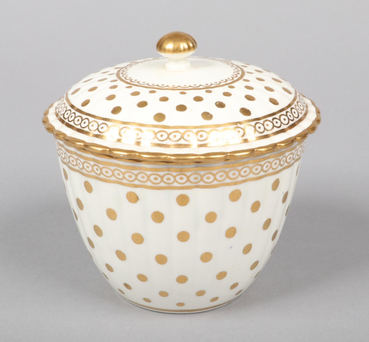 A Caughley fluted sucrier and cover. Decorated in gilt with the Polka Dot pattern c.1780, 11cm high.