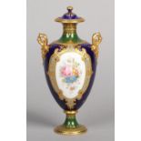 A fine Royal Crown Derby twin handled pedestal urn and cover by Desire Leroy. With raised gilding on