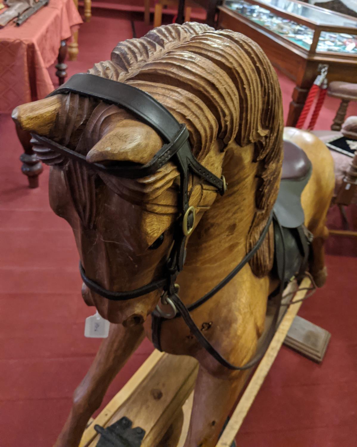 A large carved hardwood child's rocking horse with leather saddle and bridle, 105cm high. Stripped - Image 6 of 8