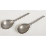 A near pair of 16th century latten slip top spoons. Each with a fig shaped bowl stamped with a