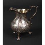 A Victorian silver three footed cream jug with gilt interior by Francis David Dexter. With double