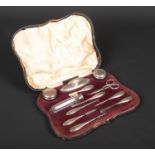 An assembled cased silver mounted manicure set by Walker & Hall. Assayed Birmingham 1913 and 1939.