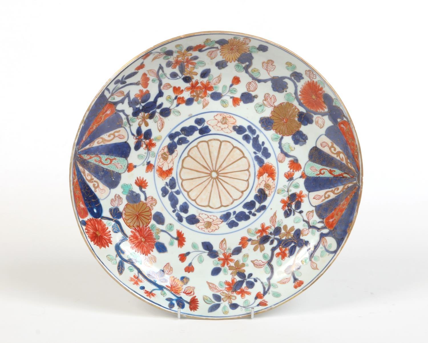 A 19th century Chinese Imari dish. Painted with a brocade pattern incorporating mons and trailing