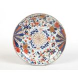 A 19th century Chinese Imari dish. Painted with a brocade pattern incorporating mons and trailing