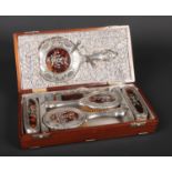 A George V silver backed and tortoiseshell brush set by William Adams Ltd in mahogany case having