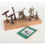 Eight corkscrews mounted on an oak plinth. Along with a reference book, I Cavatappi, Corkscrews,