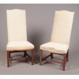 A pair of George II style 19th century mahogany framed high backed hall chairs, 114cm high, seat