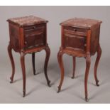 A pair of early 20th century French kingwood and rosewood marble top pot cupboards. Each with a