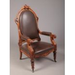 A Biedermeier carved rosewood library chair with ebonized mouldings. Leather upholstered, with