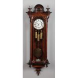 A 19th century walnut cased Vienna wall clock by Gustav Becker. With ebonized mouldings and enamel
