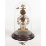 A late 20th century German brass skeleton clock on mahogany plinth and under glass dome. With one