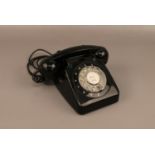 A black vintage rotary dial telephone