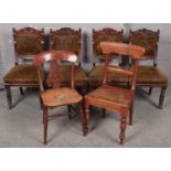A set of four carved mahogany upholstered chairs along with two other mahogany chairs.