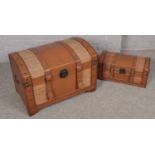 A leather and rattan mounted wooden dome top trunk along with a matching smaller example. Biggest